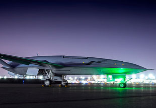 Picture of MQ-25 on runway at night.