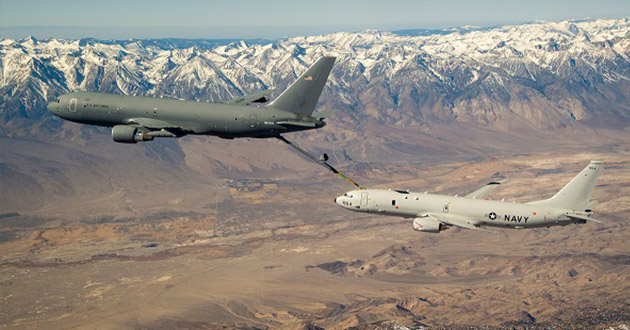   Fitted with an in-flight refueling system, a U.S. Navy P-8A practices refueling with a KC-46A tanker over the mountains of Southern California.