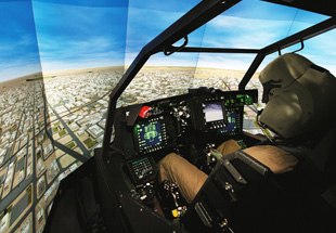  Over the shoulder picture of pilot in training simulator cockpit for Apache helicopter. Training Solutions