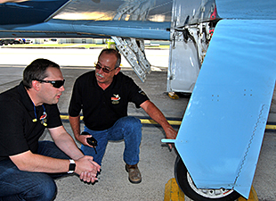 Mechanics inspecting landing gear