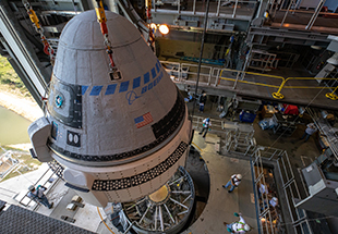 The Boeing CST-100 Starliner spacecraft is guided into position above a United Launch Alliance Atlas V rocket at the Vertical Integration Facility at Space Launch Complex 41 at Floridaâ  s Cape Canaveral Air Force Station on Nov. 21, 2019. Starliner will be secured atop the rocket for Boeingâ  s Orbital Flight Test to the International Space Station for NASAâ  s Commercial Crew Program. The spacecraft rolled out from Boeingâ  s Commercial Crew and Cargo Processing Facility at NASAâ  s Kennedy Space Center earlier in the day.